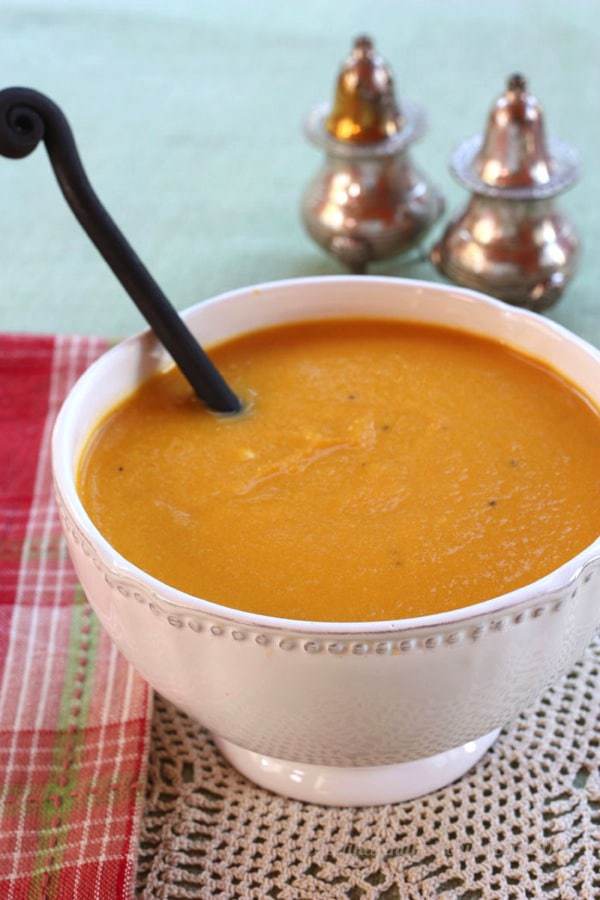 A white decorative bowl of soup