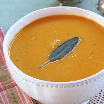 Apple Cider and Cheddar Cheese Butternut Squash Soup with a sage leaf on top