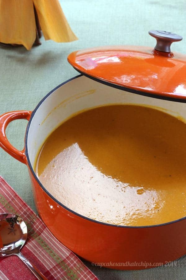 An orange pot filled with Apple Cider and Cheddar Cheese Butternut Squash Soup