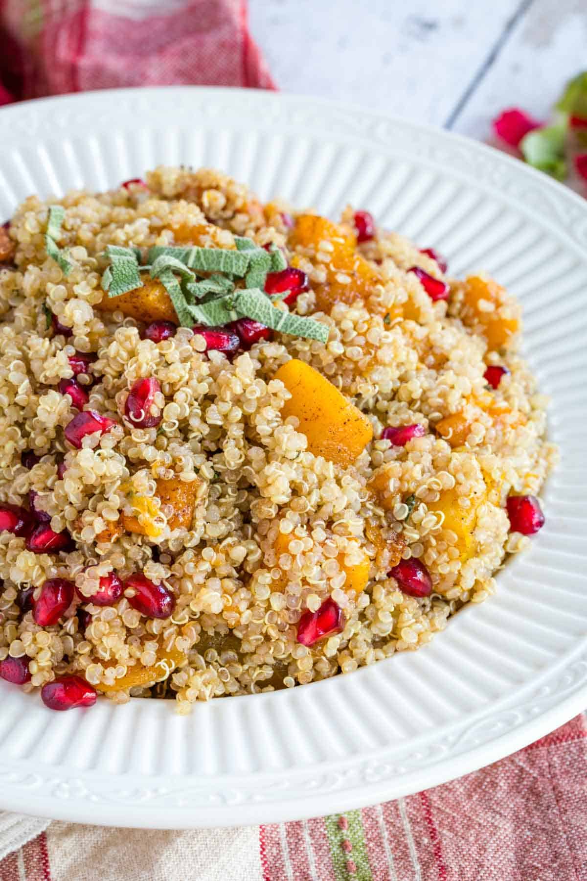 Quinoa with roasted butternut squash and pomegranate in a serving bowl.