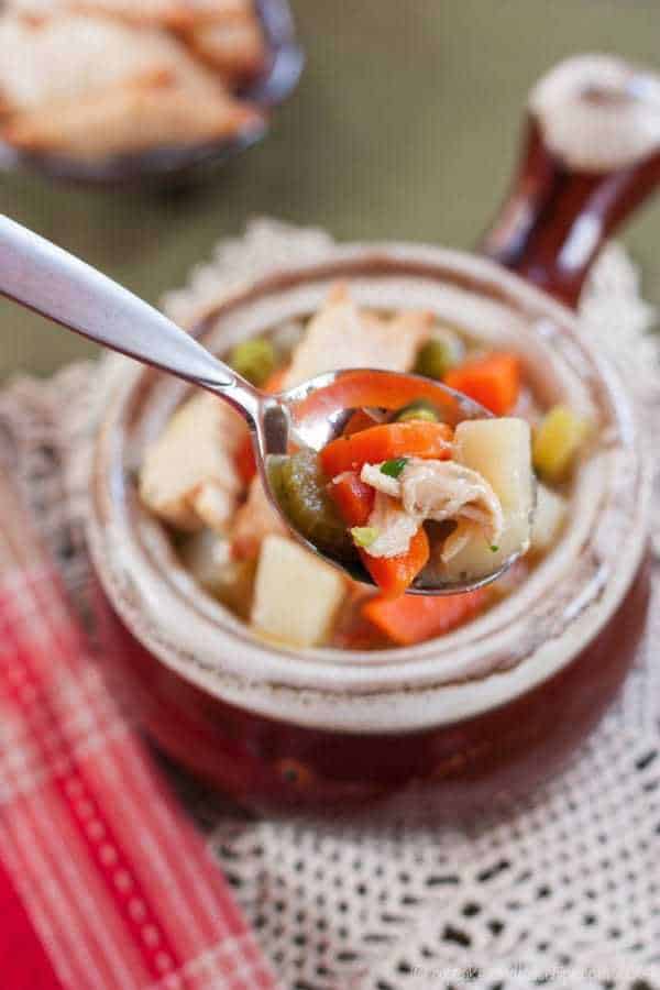 A spoon of soup with turkey meat and vegetables