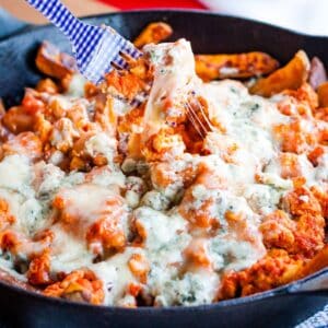 Buffalo chicken fries with blue cheese on top.