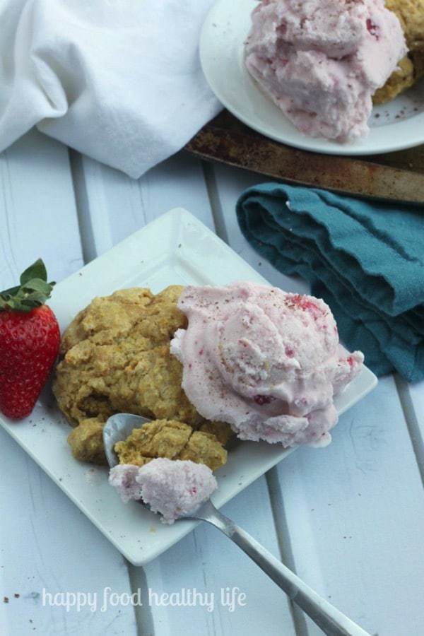 Coconut milk strawberry ice cream on top of a honey orange biscuit.