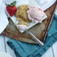 Plate of honey orange biscuits with strawberry ice cream.