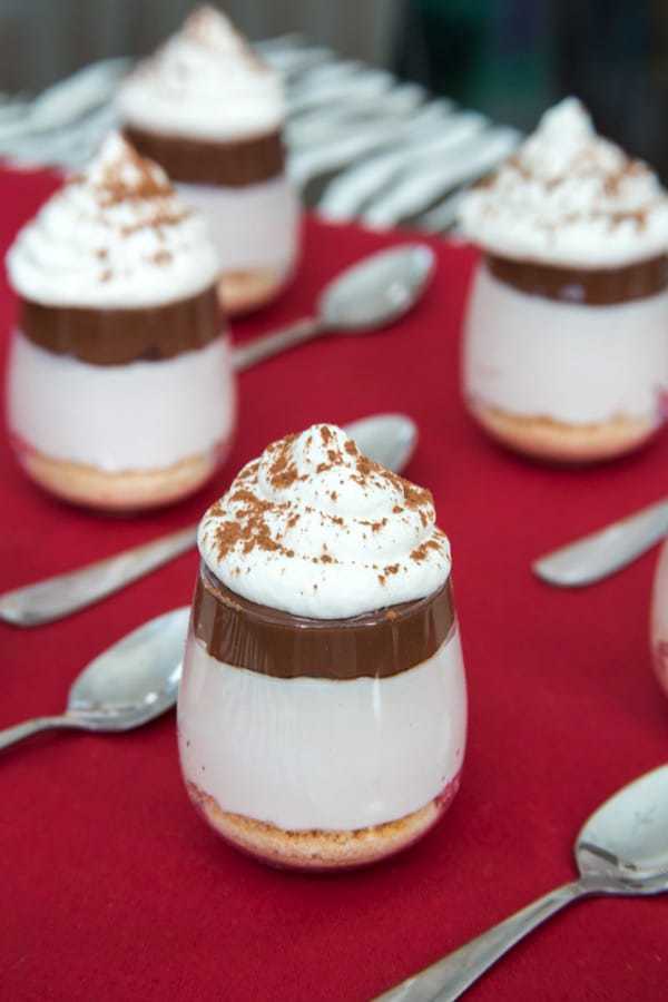 No-Bake Nutella Cheesecake Shooters - layers of cheesecake, chocolate hazelnut spread and whipped cream on top of a classic graham cracker or gluten free crust and topped with whipped cream are a simple, rich and elegant mini dessert perfect for a party! | cupcakesandkalechips.com