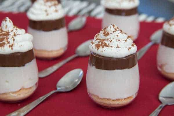 No-Bake Nutella Cheesecake Shooters - layers of cheesecake, chocolate hazelnut spread and whipped cream on top of a classic graham cracker or gluten free crust and topped with whipped cream are a simple, rich and elegant mini dessert perfect for a party! | cupcakesandkalechips.com