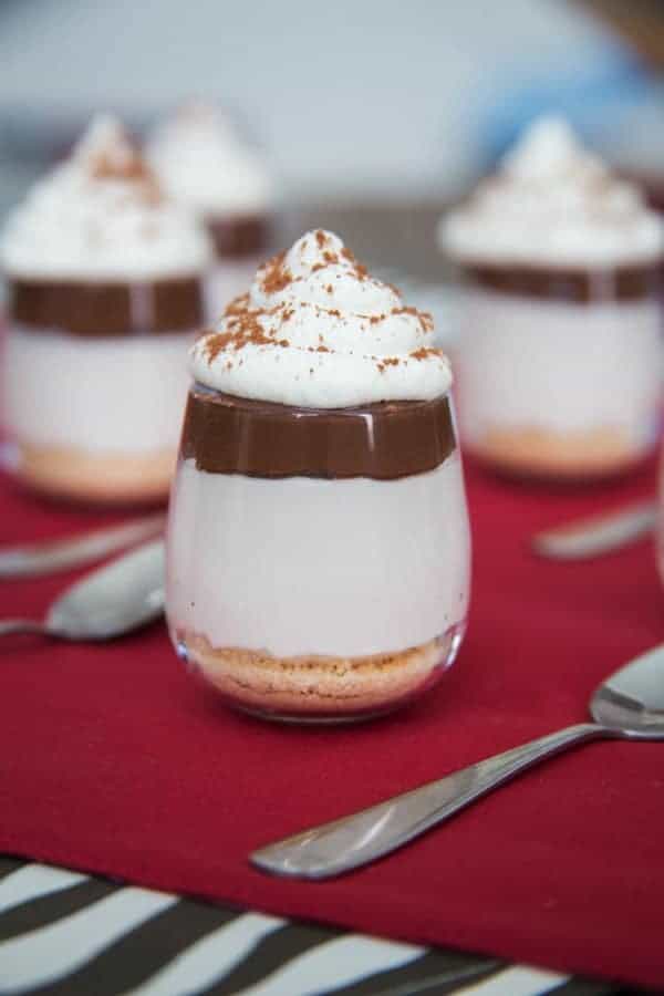 No-Bake Nutella Cheesecake Shooters - layers of cheesecake, chocolate hazelnut spread and whipped cream on top of a classic graham cracker or gluten free crust and topped with whipped cream are a simple, rich and elegant mini dessert perfect for a party! | cupcakesandkalechips.com