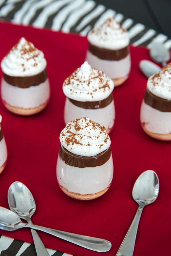 No-Bake Nutella Cheesecake Shooters - layers of cheesecake, chocolate hazelnut spread and whipped cream on top of a classic graham cracker or gluten free crust and topped with whipped cream are a simple, rich and elegant mini dessert perfect for a party! | cupcakesandkalechips.com