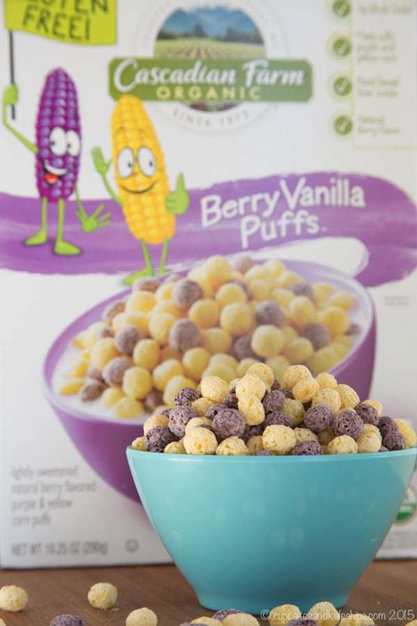 A bowl of berry vanilla puffs with the box behind it.