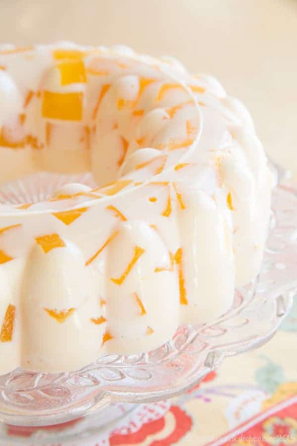 https://cupcakesandkalechips.com/wp-content/uploads/2015/03/Creamsicle-Jello-mold-recipe-600-1030.jpg