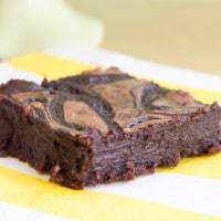 Closeup of a Bailey's Brownie with Fudge Swirl on a yellow and white striped napkin