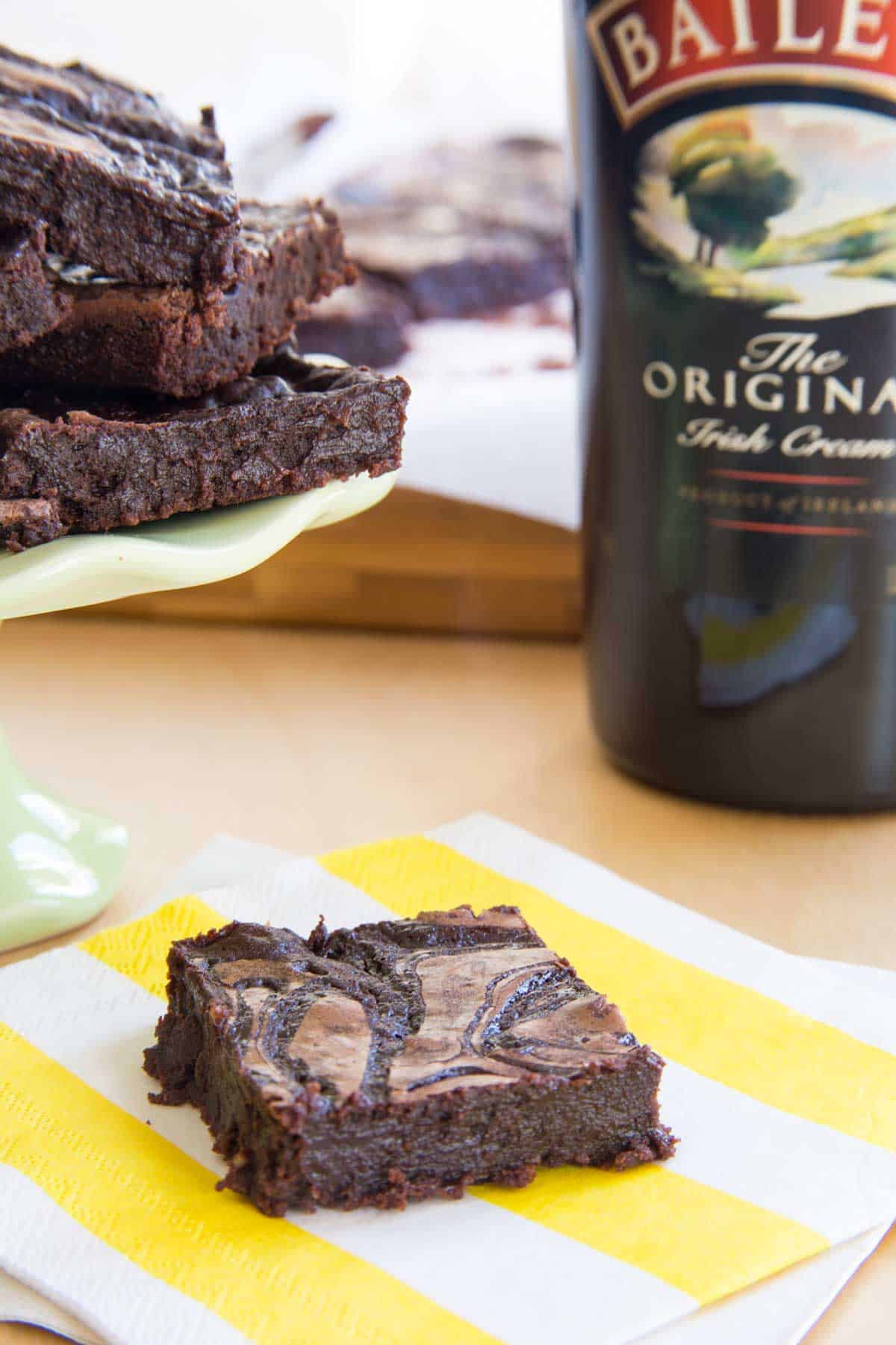 Bailey's Brownie with a jar of fudge sauce and bottle of Irish cream in the background.