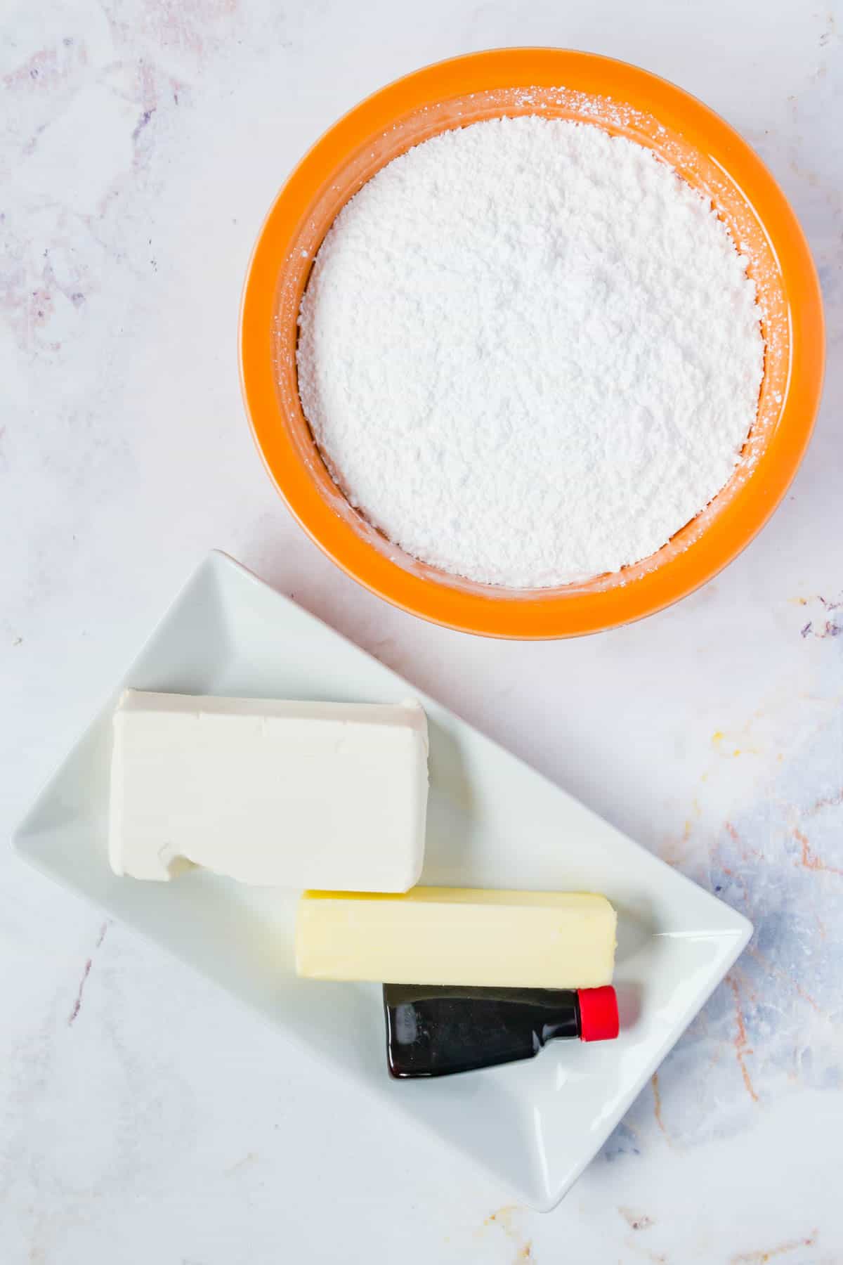 The ingredients for sweet cream cheese frosting.