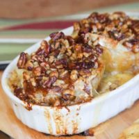 Melted brie cheese and honey nut topping oozes over baked bloomin' apples