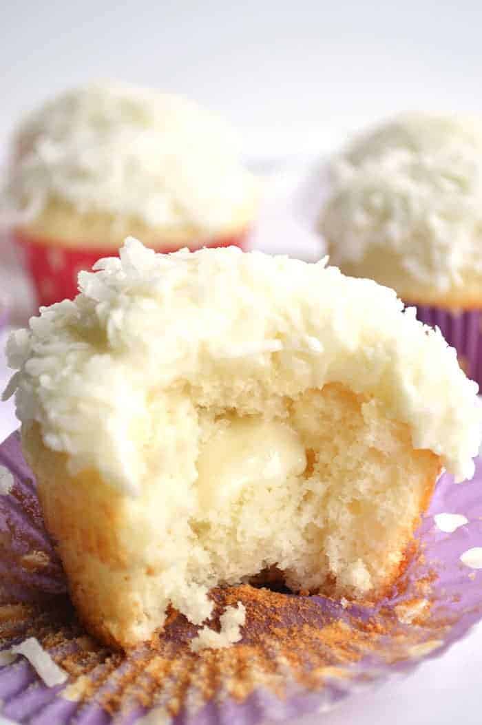 Coconut Cupcakes. A moist white coconut cake with a creamy coconut filling and coconut frosting on top! | cupcakesandkalechips.com