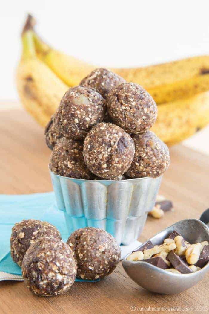 Chocolate Chunk Banana Energy Bites in a small cup with three in front