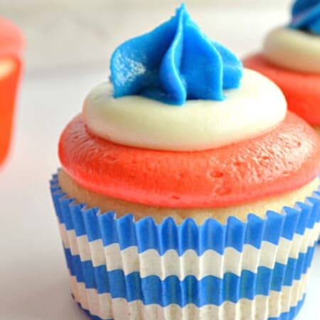 several cupcakes decorated for fourth of july with red, white, and blue frosting