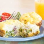 Asparagus and ham egg muffins served with a glass of orange juice
