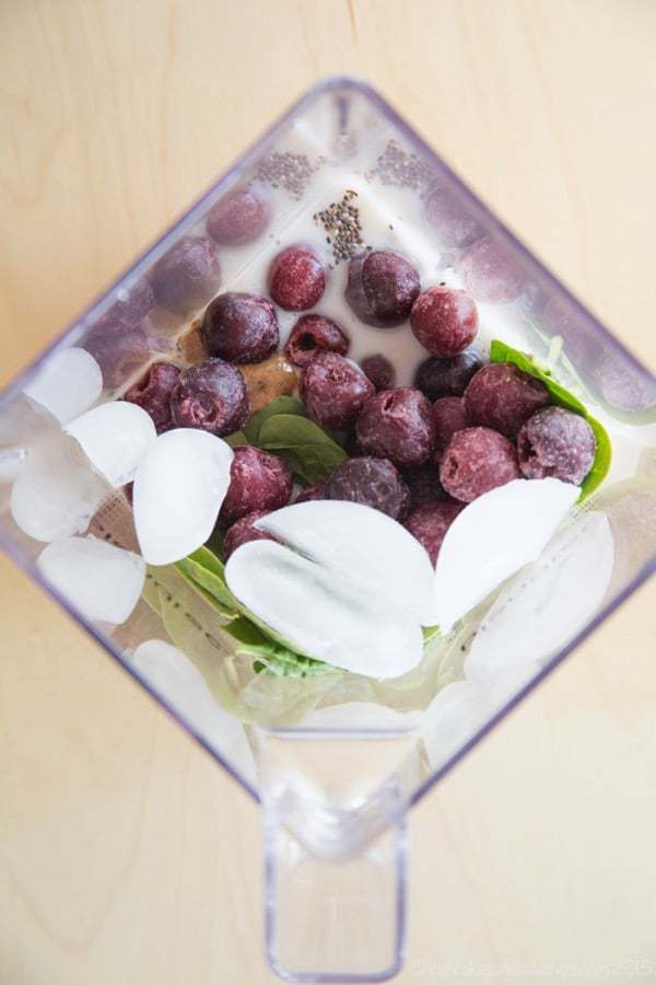 Overhead of Cherry Vanilla Almond Smoothie ingredients in a blender