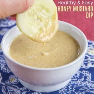 cucumber slice dipped into a bow of honey mustard dip