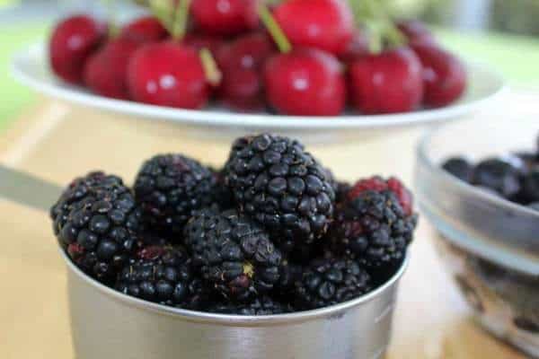 Gluten Free Blackberry, Blueberry and Cherry Crisp - Farmer’s market fresh fruits combine with a crunchy almond and oat crumb topping to make an easy Summer dessert | loveandconfections.com for cupcakesandkalechips.com