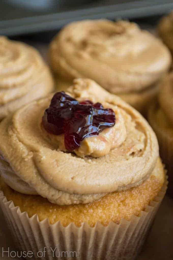 cupcakes with peanut butter frosting and one with a dollop of jelly on top