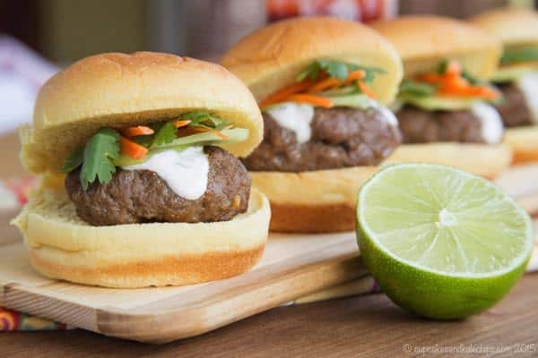 A row of Thai Sliders on a wooden platter