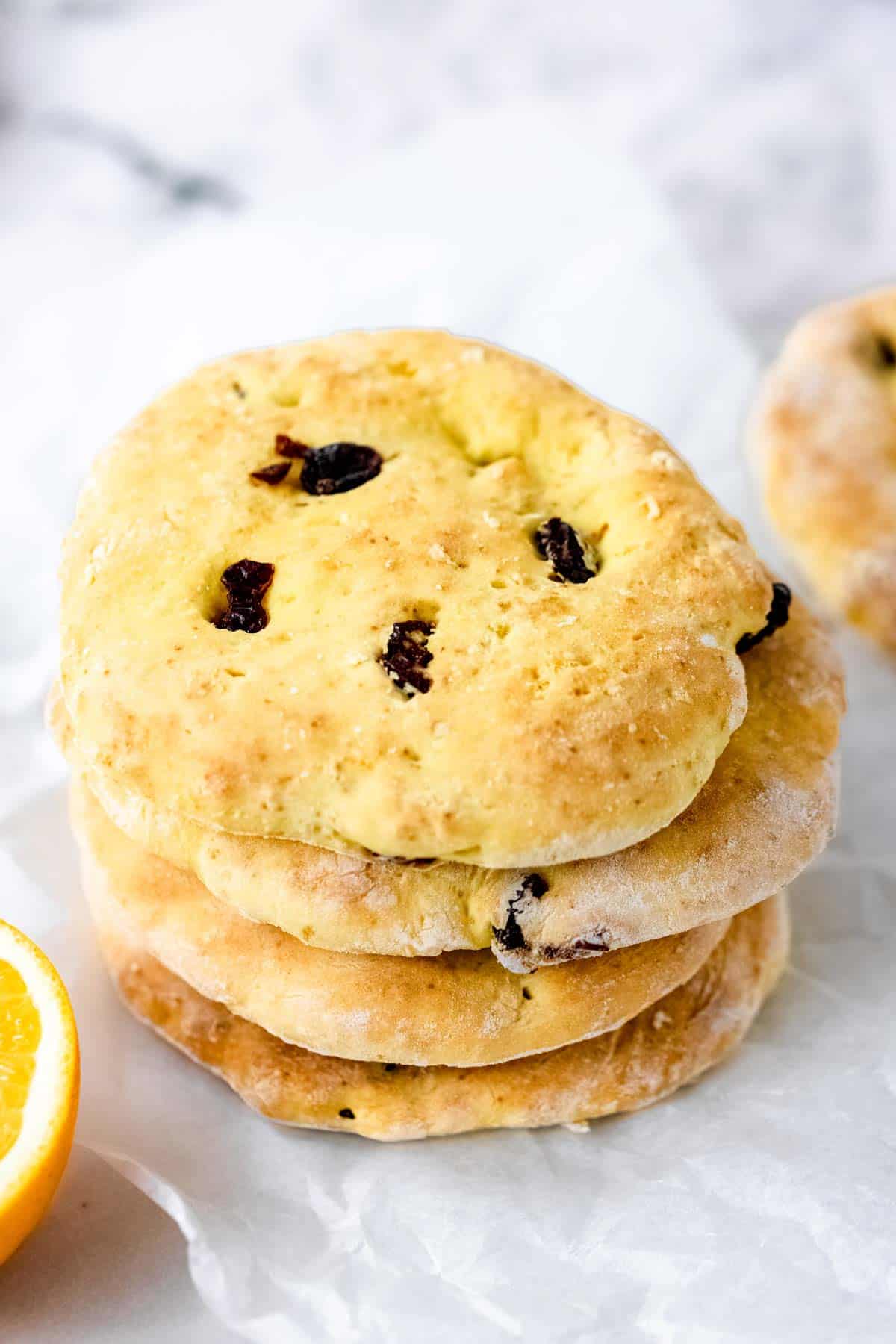 Overhead view of a stack of gluten-free cranberry orange pita bread on a marble countertop.