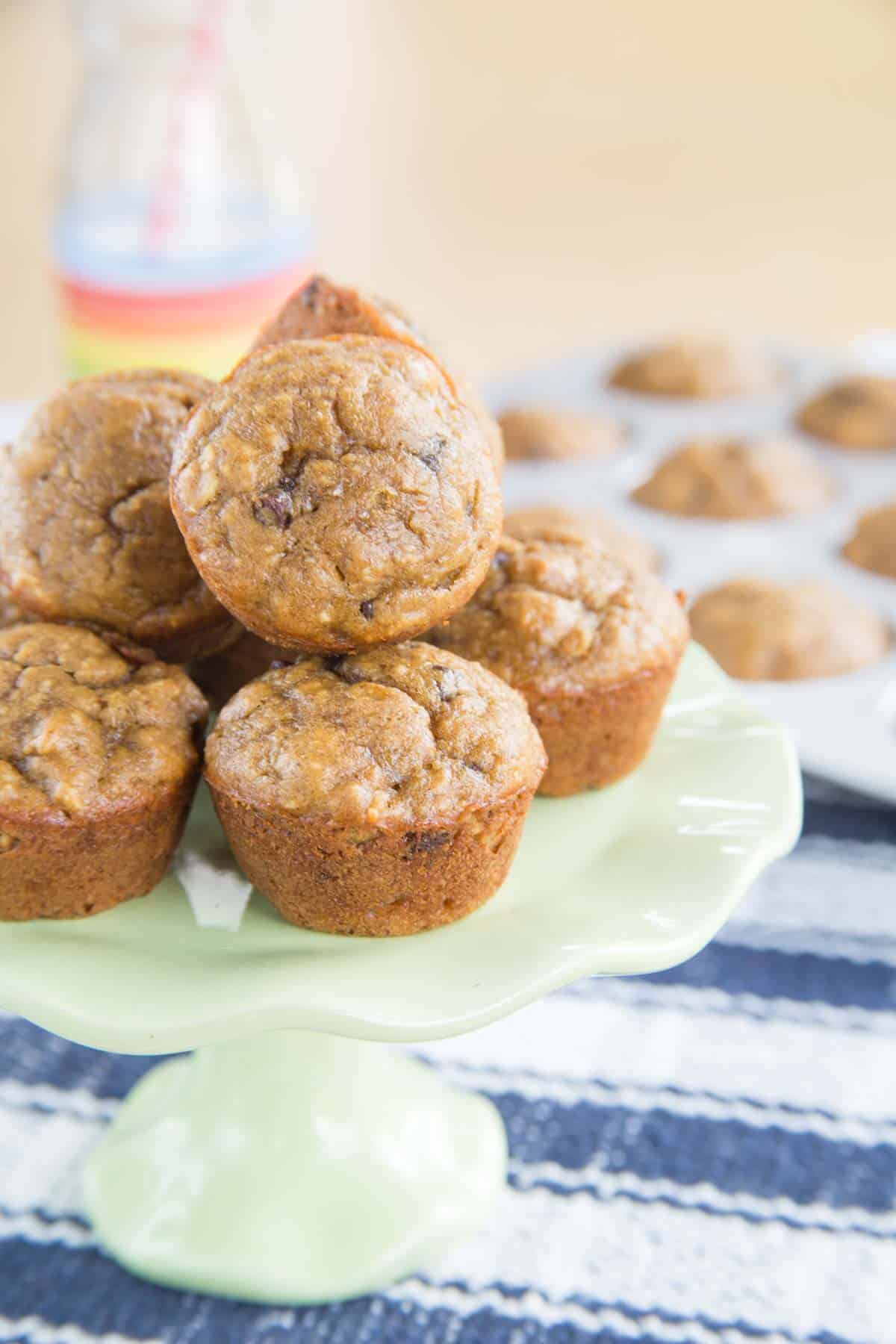 mini peanut butter banana muffins on a small light green cake stand.