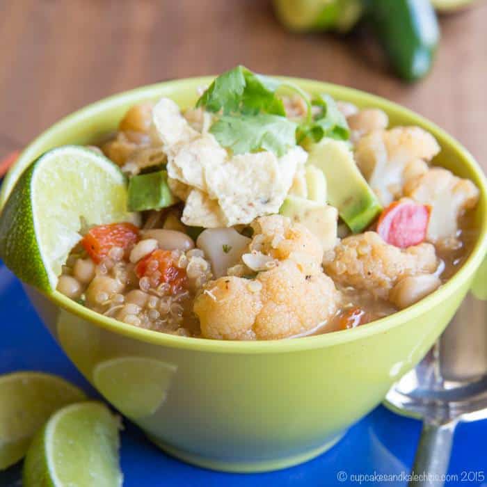 A bowl of quinoa chili garnished with a lime wedge.