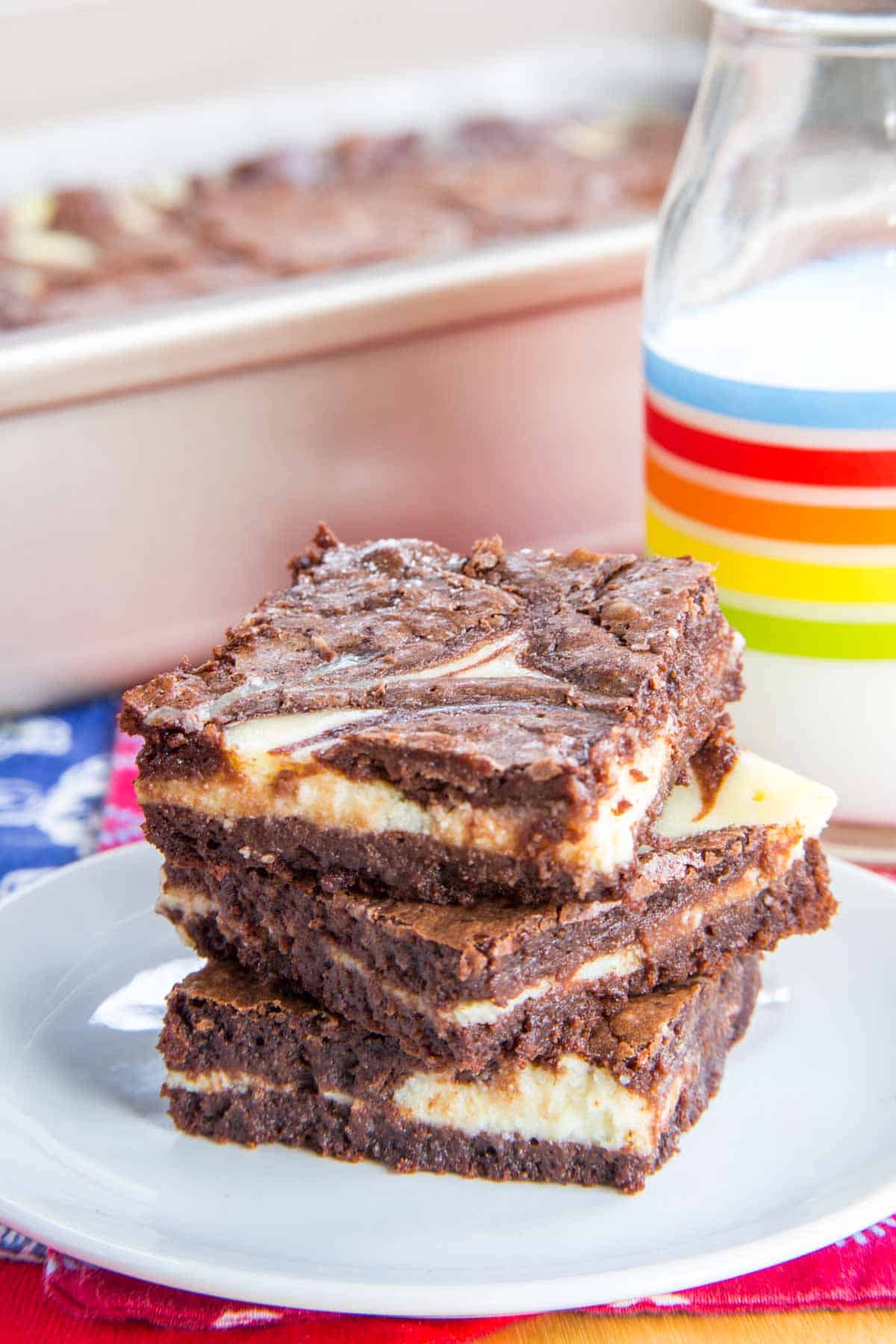 Three cheesecake brownies on a plate