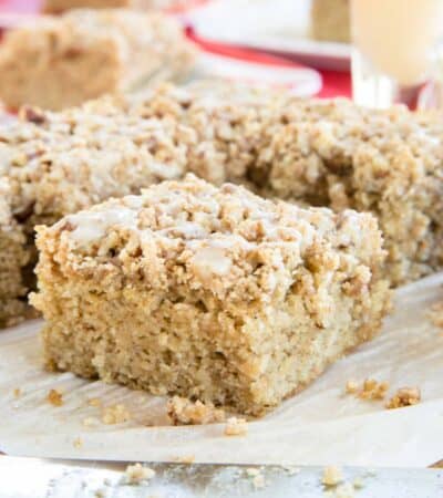 Squares of coffee cake on a cutting board with a knife laying in front.