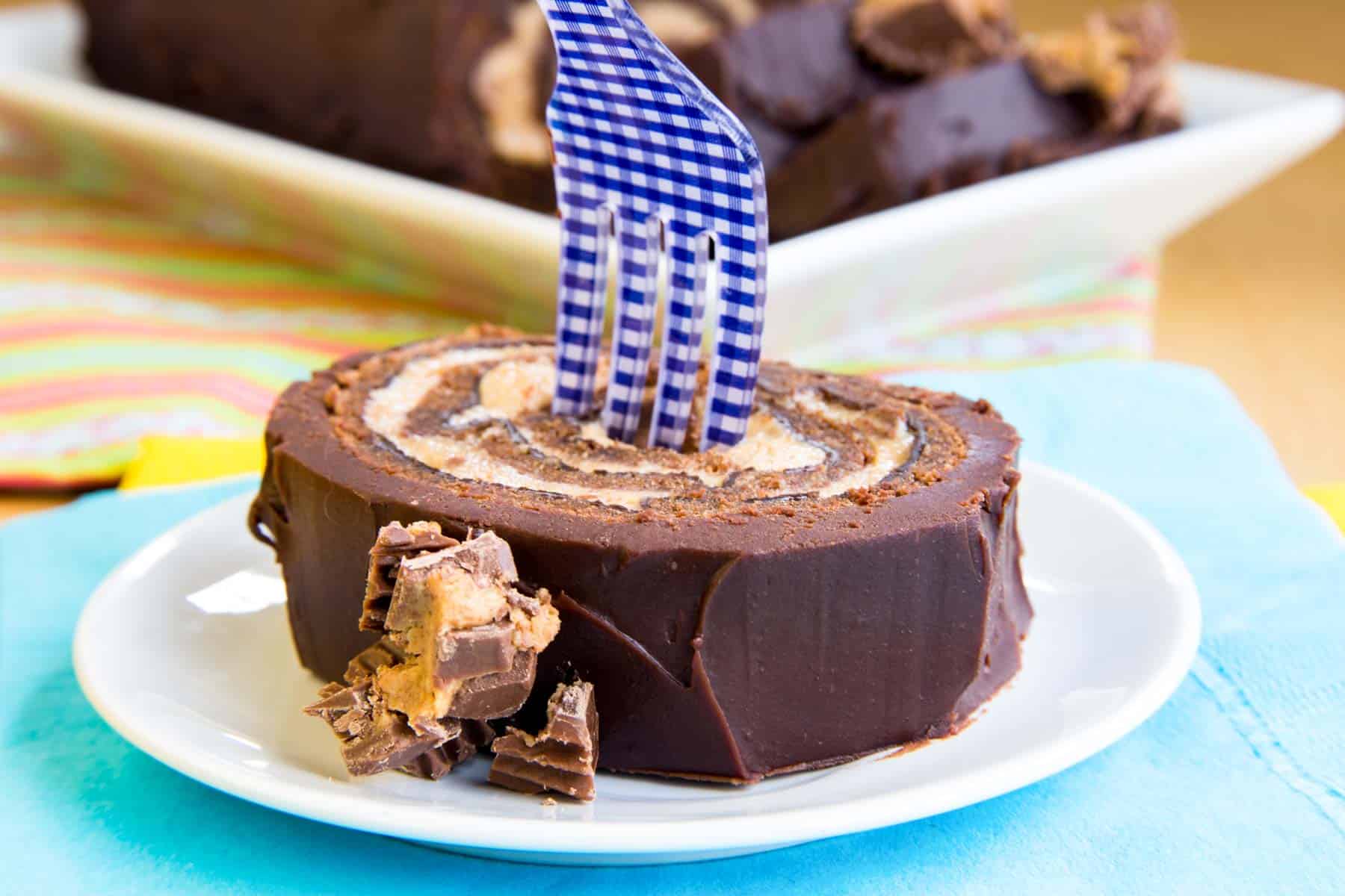 A fork in Reese's Peanut Butter Cup Flourless Chocolate Cake Roll