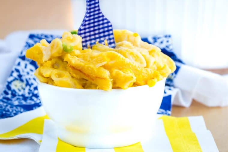 Butternut squash macaroni and cheese served in a bowl with a blue and white fork.
