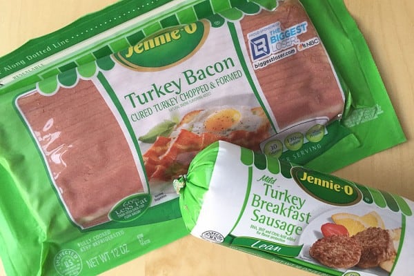 A packet of Jennie O Turkey Sausage next to a packet of turkey bacon.