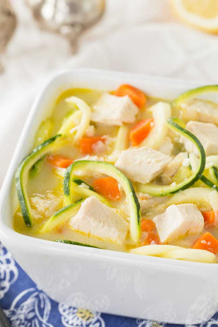 Greek Lemon Chicken Zoodle Soup in a square shaped bowl