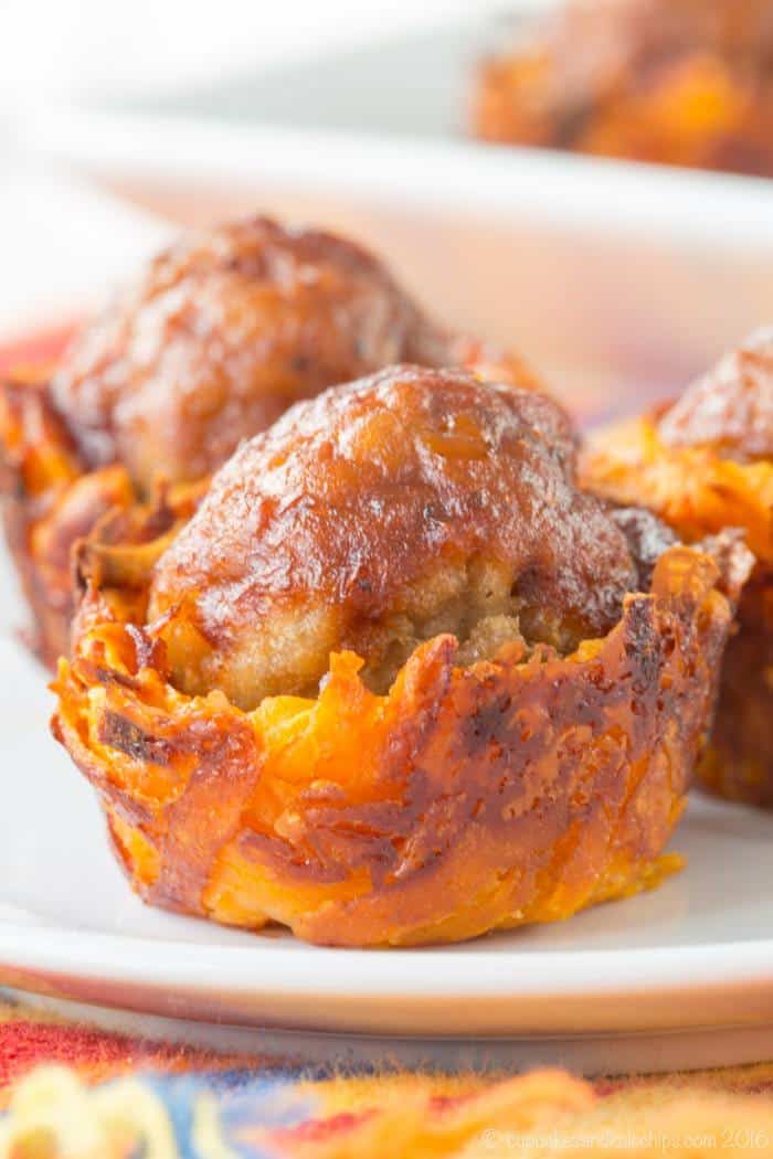 Close up of Cheesy Sweet Potato BBQ Meatball Bites on a white plate.