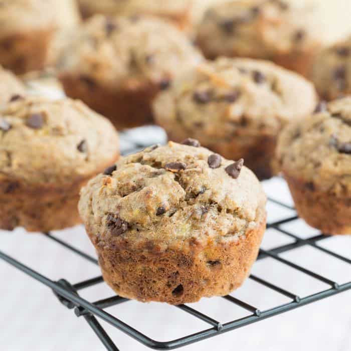Banana chocolate chip muffins on a wire rack.