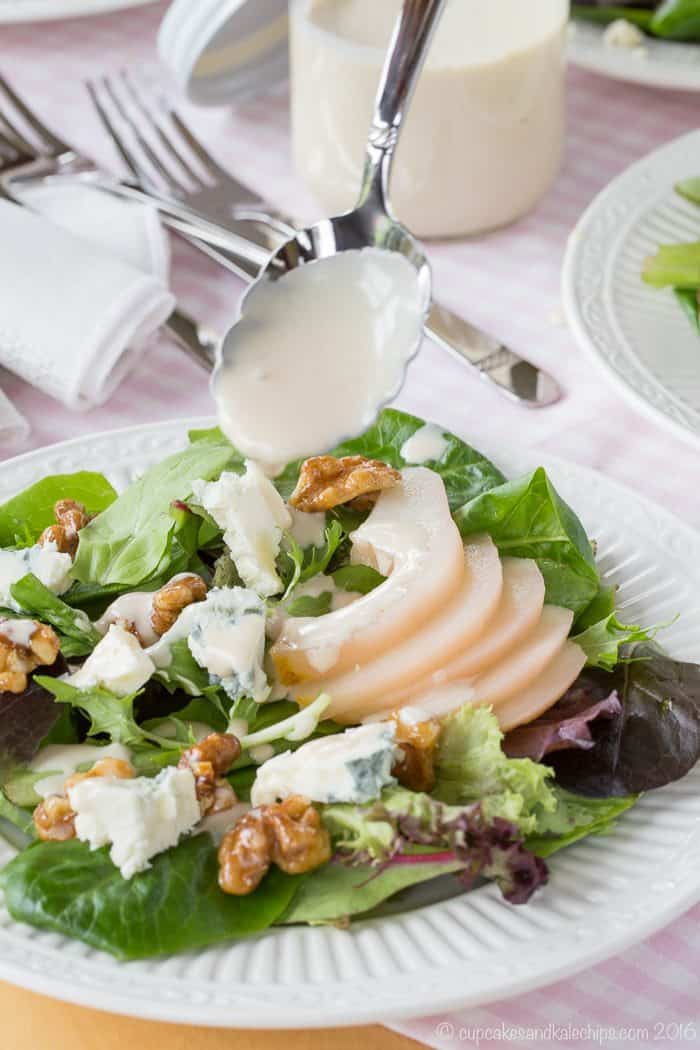 Drizzling creamy sherry dressing onto a salad from a spoon