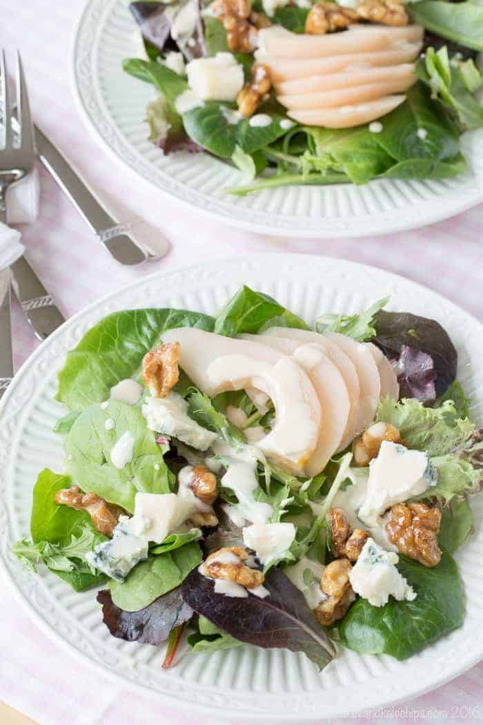 Two side salads with poached pears and blue cheese