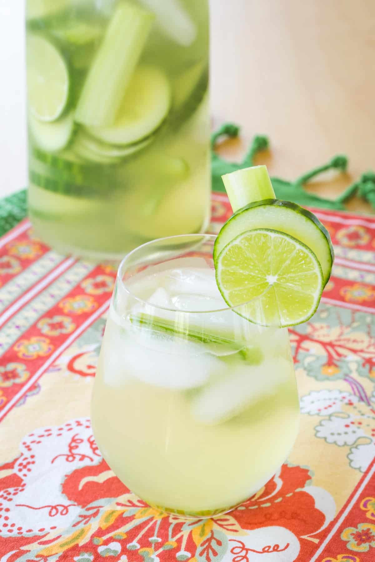 white wine cocktail in a stemless wine glass with a filled pitcher behind it