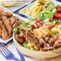 This grilled chicken sausage salad is topped with avocado, cheese, tomatoes, and corn.