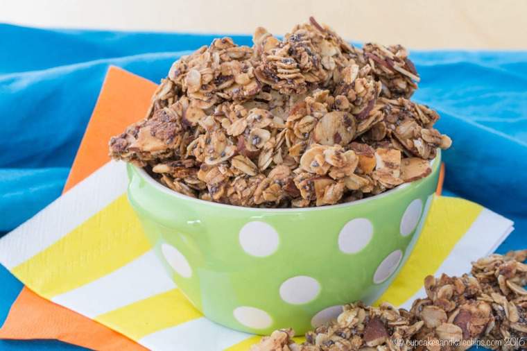 A bowl of granola clusters on colorful napkins.