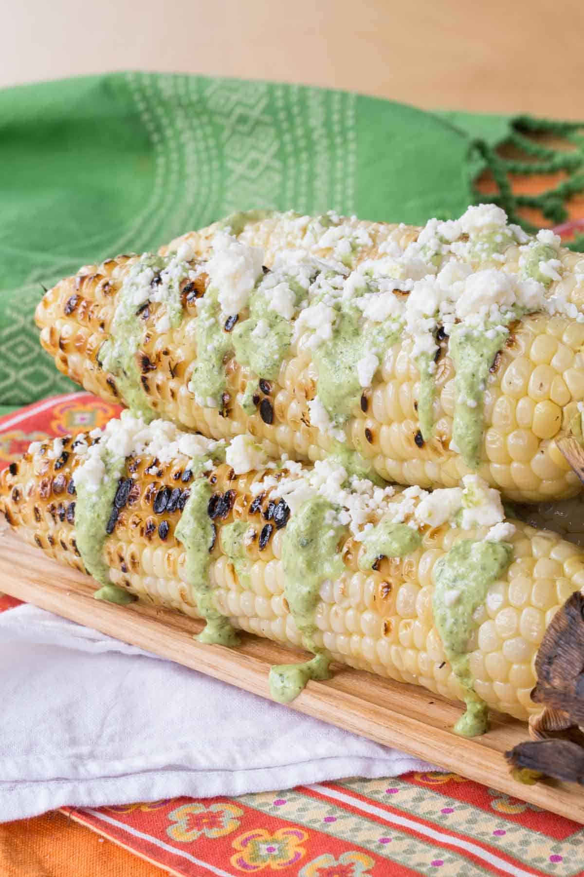 The platter of the final street corn dish on top of cloth napkins.