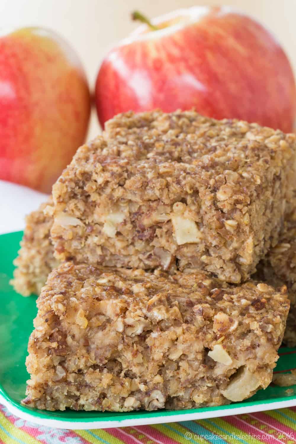 Cinnamon Apple Quinoa Breakfast Bars stacked on a green plate.