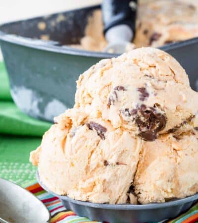 Nutella Swirl Pumpkin Ice Cream and a mini metal tart pan with a spoon alongside it.