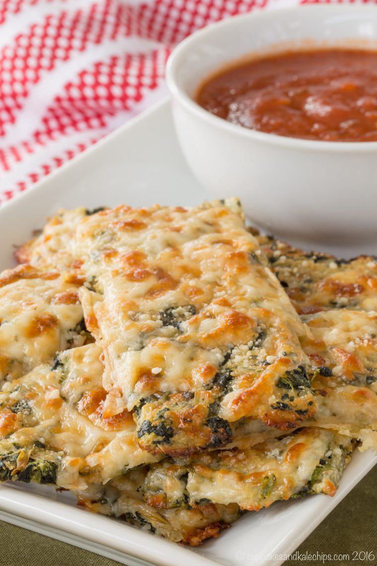 spinach artichoke cauliflower breadsticks stacked on a plate