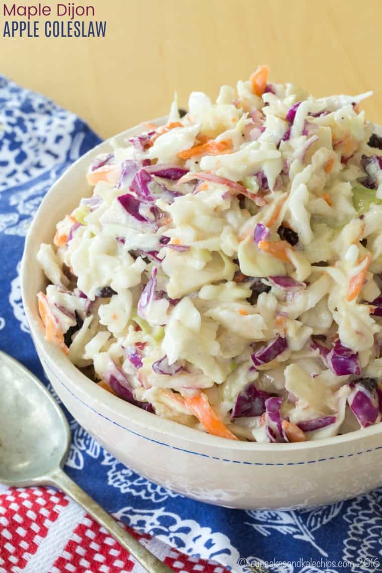 Maple Dijon Apple Coleslaw - a healthy coleslaw recipe with a lightened-up Greek yogurt dressing instead of mayo, plus apples and dried cranberries for a sweet and tangy twist on the classic picnic side dish. Serve at a summer barbecue or fall tailgate party! #cupcakesandkalechips #coleslaw #glutenfree #vegetarian #greekyogurt #sidedish #salad #tailgatefood #summerbarbecues
