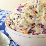 bowl of healthy coleslaw with a spoon next to it