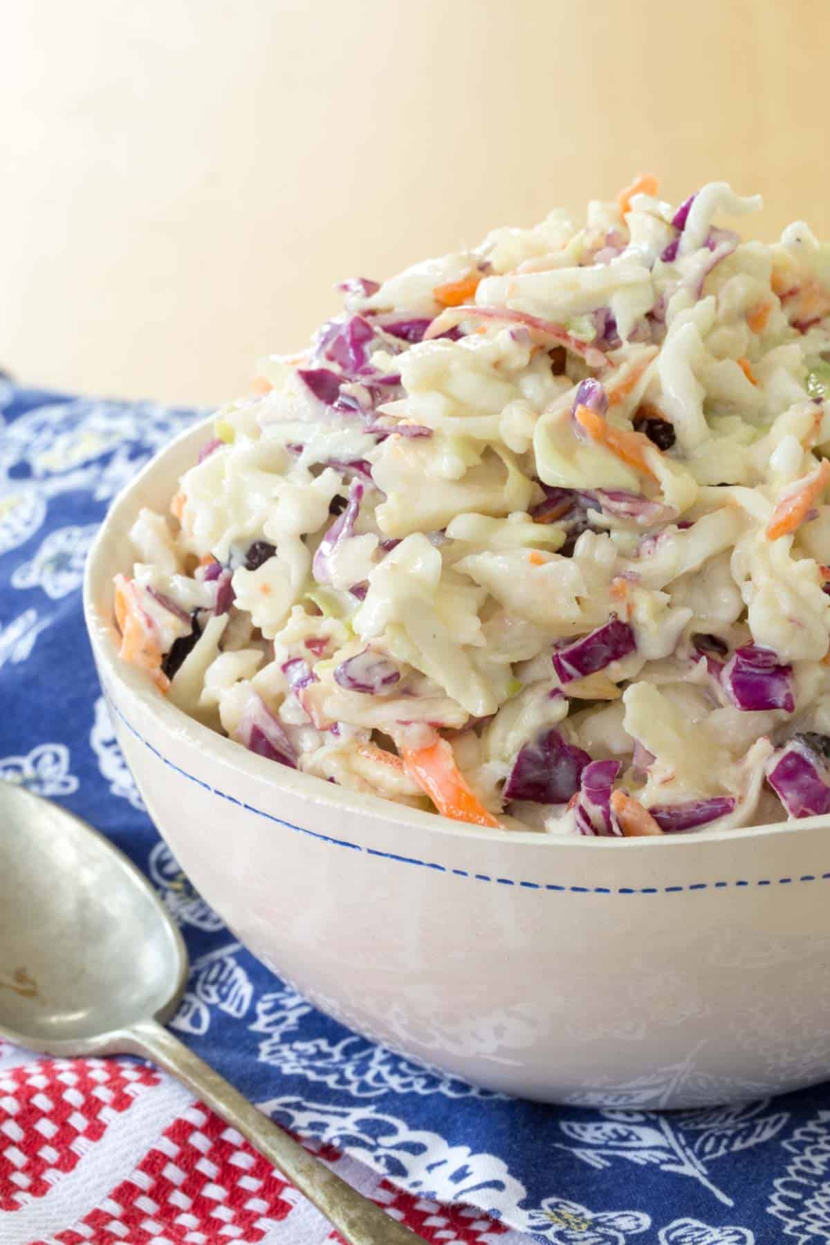 bowl of healthy coleslaw with a spoon next to it